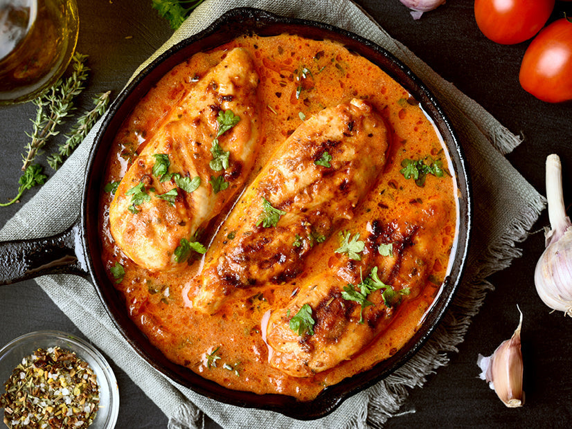 Three chicken breasts in creamy chipotle skillet sauce garnished with cilantro