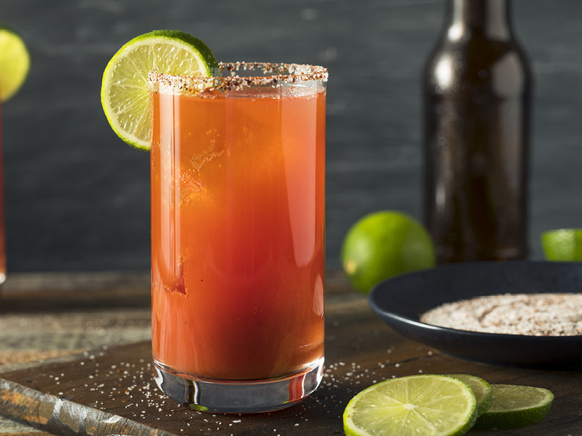 Michelada Mexican beer cocktail with Bloody Mary Mix, lime and a salted rim