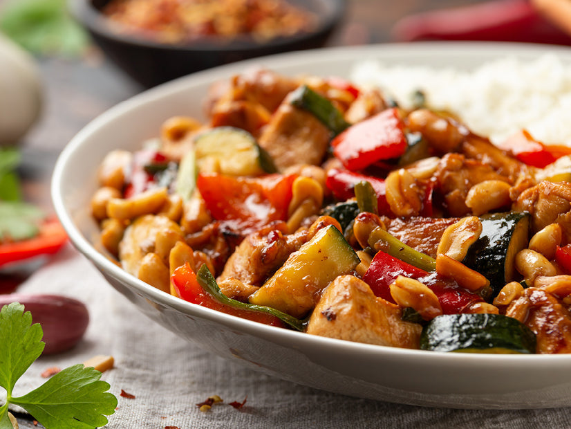 Red chile chicken stir fry with snow peas and red bell pepper over rice