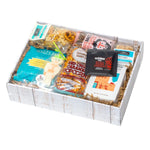 Turquoise Trail Gift Box, Red Chile, overhead view of packaged assortment including Santa Fe Gourmet Pueblo Morning Coffee, Red Chile Caramel Popcorn, Chocolate Cartel Red Chile Dark Chocolate, and Sweet Santa Fe Biscochitos